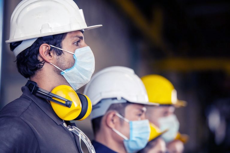 Factory workers wearing masks for COVID-19, contact tracing concept